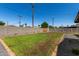 Backyard with fresh lawn, a block fence, and rock features at 1308 N 71St St, Scottsdale, AZ 85257