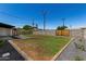 Backyard with fresh lawn, a block fence, and rock features at 1308 N 71St St, Scottsdale, AZ 85257