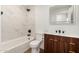 This renovated bathroom features a shower and bathtub combo at 1308 N 71St St, Scottsdale, AZ 85257