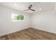Bright bedroom features wood-look floors, a ceiling fan, and a view of the outdoors at 1308 N 71St St, Scottsdale, AZ 85257