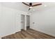 Bedroom with wood-look floors, ceiling fan, closet, and view of ensuite bath at 1308 N 71St St, Scottsdale, AZ 85257
