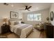 Serene bedroom featuring a large window, ceiling fan, and soft color scheme, creating a peaceful ambiance at 1308 N 71St St, Scottsdale, AZ 85257
