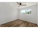 Bright bedroom features wood-look floors, a ceiling fan, and a window with a backyard view at 1308 N 71St St, Scottsdale, AZ 85257