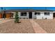 Charming single-story home featuring a landscaped front yard and a welcoming brick pathway at 1308 N 71St St, Scottsdale, AZ 85257