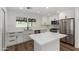 Modern kitchen featuring white cabinets, stainless steel appliances, and an island with quartz countertop at 1308 N 71St St, Scottsdale, AZ 85257