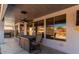 Inviting back patio featuring outdoor seating, ceiling fan, and large windows for enjoying the outdoor view at 13628 W San Miguel Ave, Litchfield Park, AZ 85340