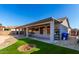 Spacious backyard with covered patio, artificial grass, and cozy fire pit, ideal for outdoor entertaining at 13628 W San Miguel Ave, Litchfield Park, AZ 85340