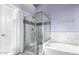 Modern bathroom with a glass-enclosed shower, soaking tub, and stylish tile work at 13628 W San Miguel Ave, Litchfield Park, AZ 85340