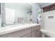 Bright bathroom featuring double sinks with quartz countertops, mosaic backsplash, and well-lit vanity mirror at 13628 W San Miguel Ave, Litchfield Park, AZ 85340