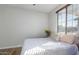 Bright bedroom featuring a cozy bed with stylish bedding and natural light from the window at 13628 W San Miguel Ave, Litchfield Park, AZ 85340