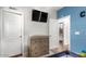 A bedroom includes a mounted TV, dresser, changing table, and well-lit, neutral toned walls at 13628 W San Miguel Ave, Litchfield Park, AZ 85340