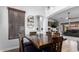 Dining table set featuring a modern chandelier, natural light from the window, and views to the living room at 13628 W San Miguel Ave, Litchfield Park, AZ 85340