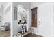 Open entryway featuring wood floors, a welcome sign, and views into the living spaces at 13628 W San Miguel Ave, Litchfield Park, AZ 85340