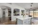 Bright open kitchen featuring an island with marble countertops and modern finishes, seamlessly connecting indoor and outdoor spaces at 13628 W San Miguel Ave, Litchfield Park, AZ 85340