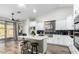 Well-lit kitchen featuring an island with a white countertop and modern appliances, ideal for cooking and entertaining at 13628 W San Miguel Ave, Litchfield Park, AZ 85340