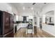 Contemporary kitchen with stainless steel appliances, white cabinets, and center island, perfect for Gathering gatherings at 13628 W San Miguel Ave, Litchfield Park, AZ 85340