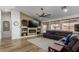 Open-concept living room features wood floors, a fireplace, and abundant natural light at 13628 W San Miguel Ave, Litchfield Park, AZ 85340