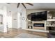 Bright and spacious living room featuring wood floors, a fireplace, and a high ceiling at 13628 W San Miguel Ave, Litchfield Park, AZ 85340