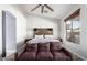 Bright main bedroom features a comfortable bed, sofa, and ample natural light, creating a relaxing retreat at 13628 W San Miguel Ave, Litchfield Park, AZ 85340