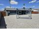Expansive backyard with rock landscaping, pergola, covered patio and mature palm trees at 13629 N 36Th St, Phoenix, AZ 85032