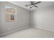 An empty bedroom with two large windows allowing for natural light at 15626 W Georgia Dr, Surprise, AZ 85379