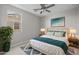 Cozy bedroom featuring a comfortable bed, two large windows, and stylish decor at 15626 W Georgia Dr, Surprise, AZ 85379