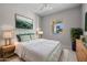 Nicely decorated bedroom with bright white comforter and matching end tables at 15626 W Georgia Dr, Surprise, AZ 85379