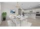 Elegant dining area with a marble table, seating for six, and a view of the modern kitchen at 15626 W Georgia Dr, Surprise, AZ 85379