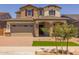 Beautiful two-story home with stone accents, a two-car garage, and a well-manicured front lawn at 15626 W Georgia Dr, Surprise, AZ 85379