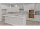 Modern kitchen featuring white cabinetry, a center island, and stainless steel appliances at 15626 W Georgia Dr, Surprise, AZ 85379