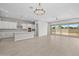 Open-concept living space with kitchen, dining area, and access to the backyard, creating a seamless flow at 15626 W Georgia Dr, Surprise, AZ 85379