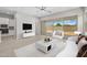 Bright living room with tile floors and sliding glass doors, staged with modern furniture at 15626 W Georgia Dr, Surprise, AZ 85379