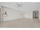 Large living room with an arched entry way, tile floors, and multiple windows at 15626 W Georgia Dr, Surprise, AZ 85379