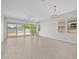 Bright living room with tile floors, large windows, and sliding glass doors to the backyard at 15626 W Georgia Dr, Surprise, AZ 85379