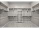 Spacious walk-in closet features built-in shelving, hanging rods and carpeted floors at 15626 W Georgia Dr, Surprise, AZ 85379