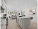 Bright, modern kitchen with white cabinets, granite countertops, stainless steel appliances, and open access to dining area at 15784 W Georgia W Dr, Surprise, AZ 85379