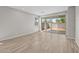 Bright living room with light wood-look floors and sliding glass doors to backyard at 15784 W Georgia W Dr, Surprise, AZ 85379