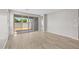 Bright living room with light wood-look floors and sliding glass doors to backyard at 15784 W Georgia W Dr, Surprise, AZ 85379
