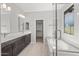 Luxurious bathroom with double vanity, soaking tub, glass shower, and walk-in closet at 15796 W Georgia W Dr, Surprise, AZ 85379
