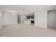 Open-concept living room with tile floors that flows into the kitchen at 15796 W Georgia W Dr, Surprise, AZ 85379
