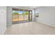 Bright and airy living room featuring sliding glass doors to the backyard and neutral tile flooring at 15796 W Georgia W Dr, Surprise, AZ 85379
