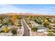 An aerial view of the neighborhood with a view of the mountains in the distance at 16436 N 64Th Pl, Scottsdale, AZ 85254
