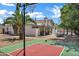 Private backyard featuring a basketball court, covered patio, outdoor seating, and lush landscaping at 16436 N 64Th Pl, Scottsdale, AZ 85254