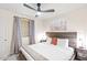 Comfortable bedroom features a ceiling fan, large bed, and desert art at 16436 N 64Th Pl, Scottsdale, AZ 85254