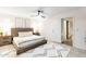 Bright bedroom featuring a ceiling fan, neutral color scheme, and access to an adjacent bathroom at 16436 N 64Th Pl, Scottsdale, AZ 85254
