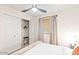 This bedroom has a ceiling fan, closet, and window with stylish curtains at 16436 N 64Th Pl, Scottsdale, AZ 85254