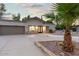 Charming single story home with a circular driveway, desert landscaping, and a two-car garage at 16436 N 64Th Pl, Scottsdale, AZ 85254