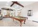 Spacious game room with a billiard table, leather seating, and vaulted ceilings at 16436 N 64Th Pl, Scottsdale, AZ 85254
