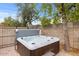 Hot tub in backyard setting with privacy fence and shade from the trees at 16436 N 64Th Pl, Scottsdale, AZ 85254