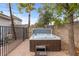 Outdoor hot tub featuring a brown cabinet, stone surround, and step at 16436 N 64Th Pl, Scottsdale, AZ 85254